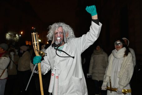 Dieser Demonstrant trägt sogar eine Maske. Und eine Gartenfackel, ein Schwert und einen Arztkittel: Er stellt den französischen Mediziner Dr. Didier Raoult dar, einen prominenten Kritiker der Corona-Maßnahmen.