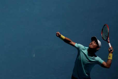Japan's Yoshihito Nishioka serves against Denmark's Holger Rune during their men's singles match on day three of the Australian Open tennis tournament in Melbourne on January 16, 2024 (Photo by Martin KEEP / AFP) / -- IMAGE RESTRICTED TO EDITORIAL USE - STRICTLY NO COMMERCIAL USE --